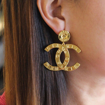 CC gold button earrings